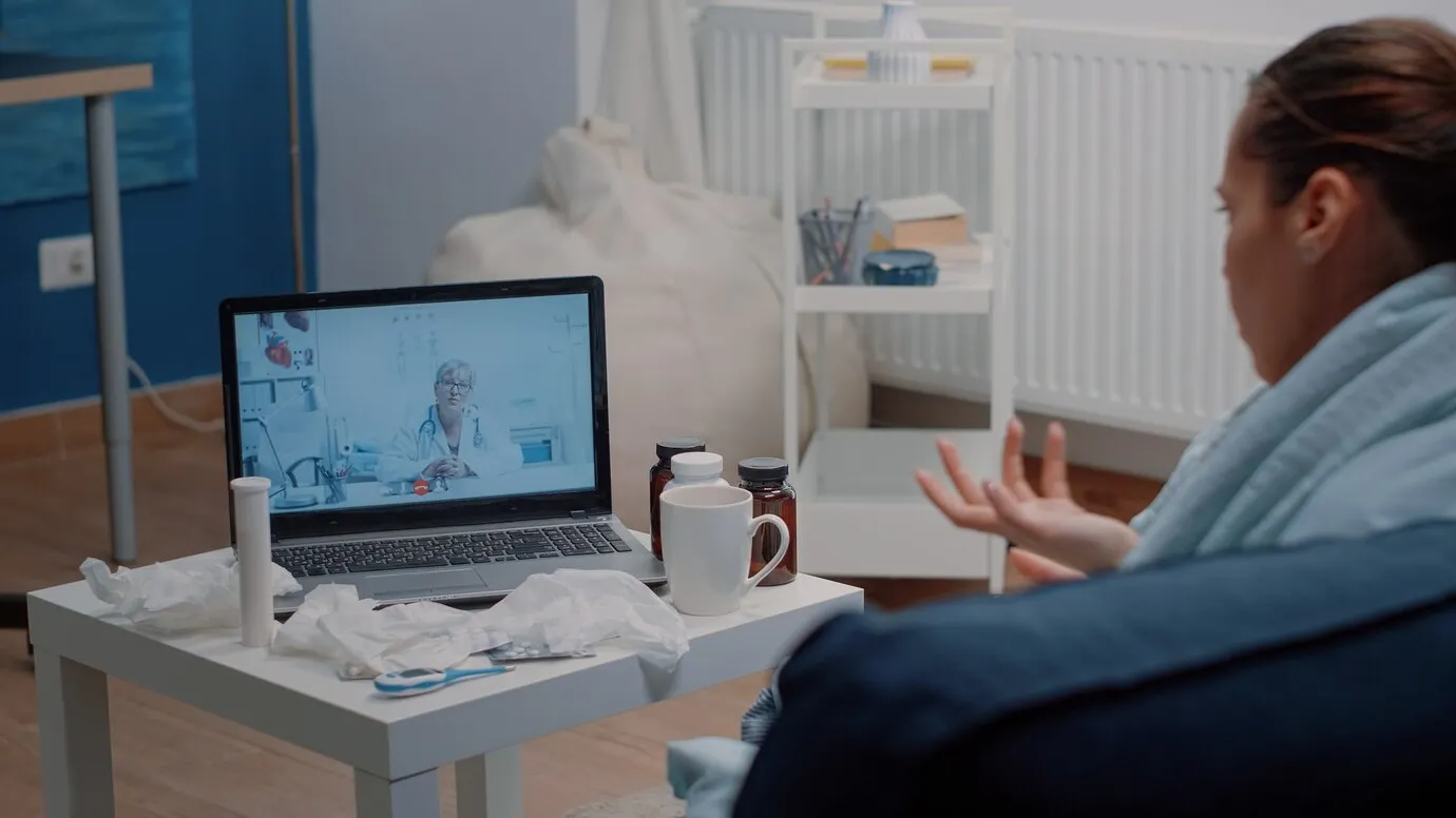 Illustration of a clinician reviewing remote monitoring data with a patient over WebRTC